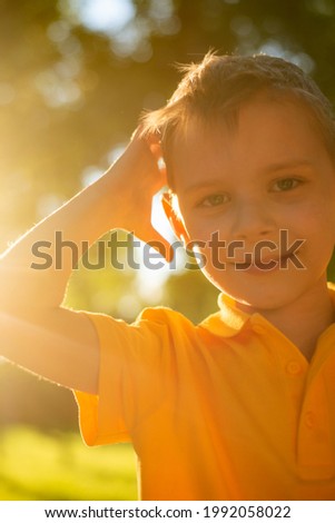 portrait of a boy in the sunlight in summer