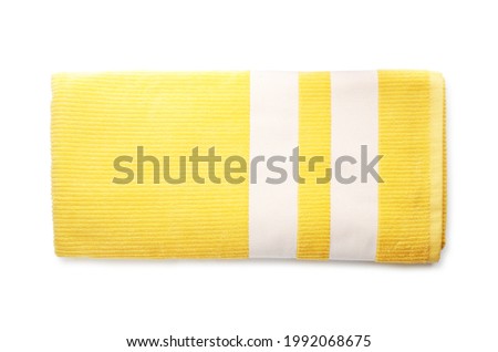 Folded yellow towel isolated on white, top view. Beach object Royalty-Free Stock Photo #1992068675