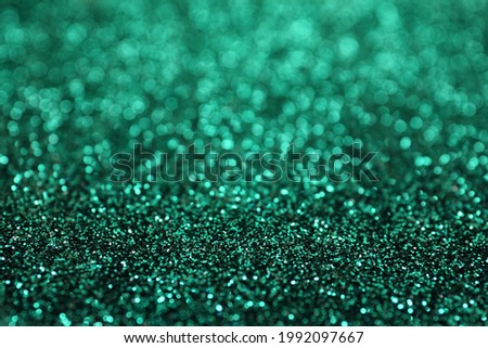 Shiny green glitter as background. Bokeh effect