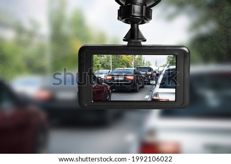 Modern dashboard camera mounted in car, view of road during driving Royalty-Free Stock Photo #1992106022