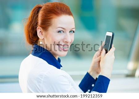 Closeup portrait, happy, cheerful, excited girl, using cell phone, taking picture isolated background corporate office. Facial expression, reaction. Business woman sending text message from mobile.
