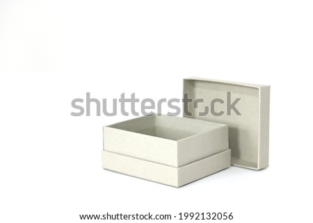 Gift mini box in gray color made of designer paper on a white background with an open lid