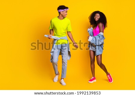 Photo of beautiful funky young couple dressed denim outfit dancing isolated yellow color background