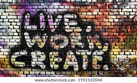 Live, work, create - Graffiti artwork with motivation motto on brick wall