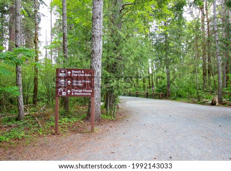 Information sign board before entering the forest: Beach and Day use area, Group picnic shelter and Change house and washrooms ahead. 