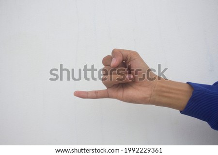 Isolated hand showing little finger on white background, sign making an appointment