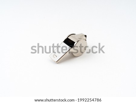 Metal whistle isolated on white background.