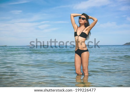Beautiful woman in bikini swimsuit on the sea 