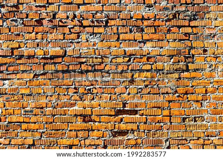 Wall texture from red old damaged bricks. Abstract background for design.