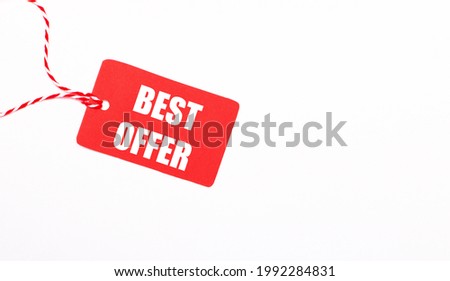 The inscription BEST OFFER on a red price tag on a light background. Advertising concept. Copy space