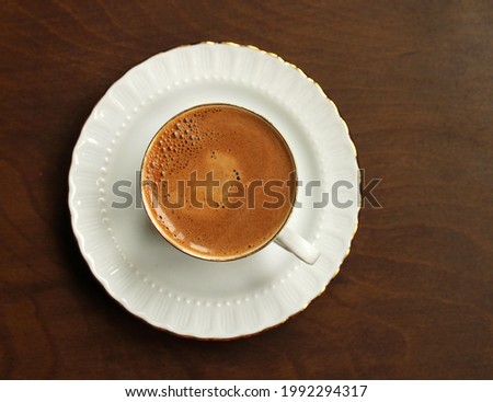 Coffee in the cup, top view, wooden background

