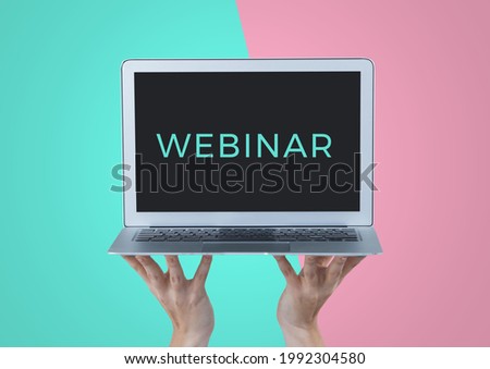 Composition of webinar text on screen of laptop held by hands, on turquoise and pink background. seminar design template concept digitally generated image.