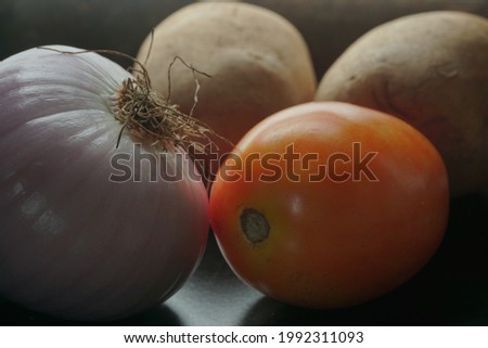 Picture of onion, potato and tomato together