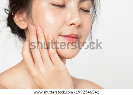 Closeup beauty skin face.  Asian woman with beauty face touching healthy facial skincare. Beautiful girl model with fresh skin face touching  skin face on white background. Royalty-Free Stock Photo #1992346541