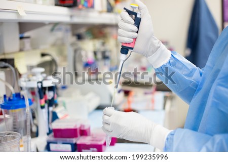 Closeup cropped portrait, scientist pipetting with hands, laboratory experiments, isolated lab background. Forensics, genetics, microbiology, biochemistry Royalty-Free Stock Photo #199235996