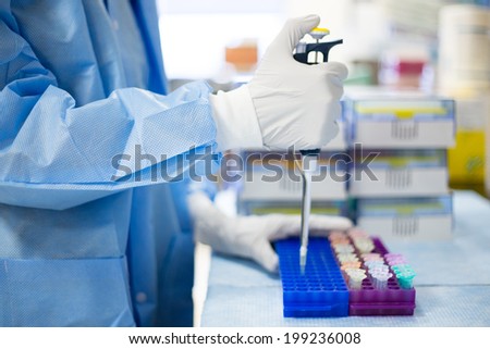 Closeup cropped portrait, scientist pipetting with hands, laboratory experiments, isolated lab background. Forensics, genetics, microbiology, biochemistry Royalty-Free Stock Photo #199236008