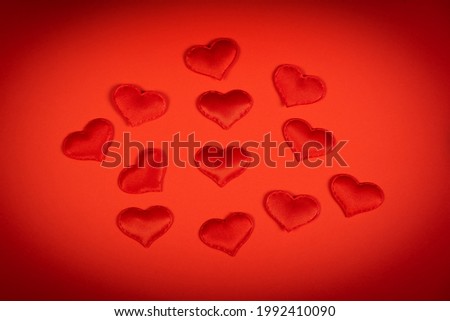 Vignetting Photo of Red Hearts on the Red Paper Background closeup