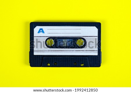 Old Audio Cassettes on the Yellow Paper Background closeup