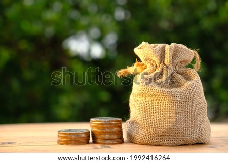 Close up stack of coin on table background and business or finance saving money, Advertising coins of finance and banking, Gold coins stacked on table background