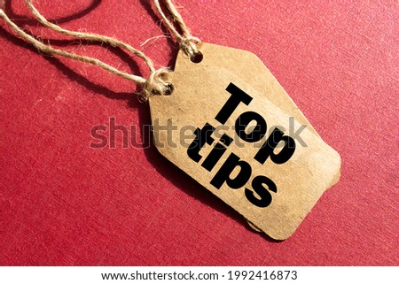 Top tips. Inscription top tips on blank tags on wooden table
