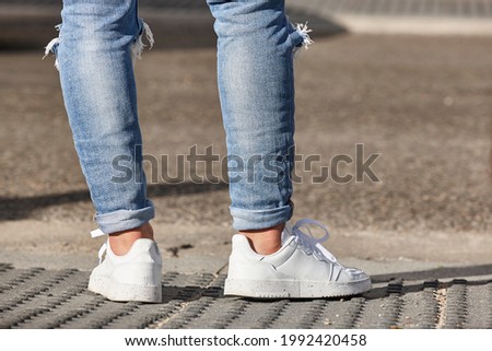 Young waiting to cross a street. Urban life. Pedestrian
