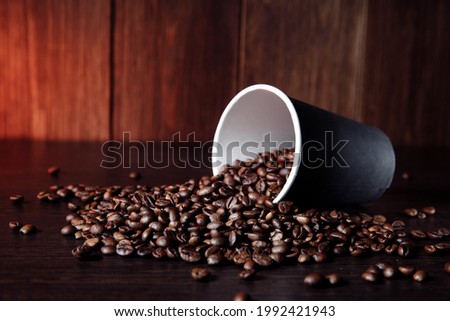 Paper cup with aromatic coffee beans