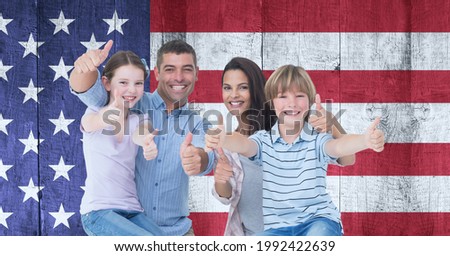 Composition of smiling caucasian couple with son and daughter giving thumbs up against american flag. united states of america patriotism and independence concept digitally generated image.