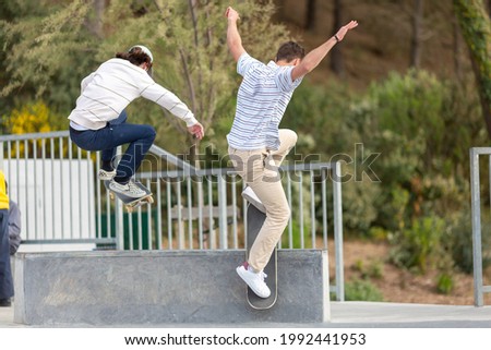 young men jumping on skateboard