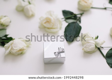 Silver jewelry ring box and white roses. Wedding, Love, Valentine's day, Proposal, Happy Birthday concept
