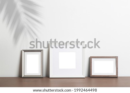 Mock up empty white frame background. Different decorative empty frames for a photo or painting in a light Scandinavian minimalist interior on a white clean wall.