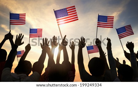 Silhouettes of People Holding the Flag of USA Royalty-Free Stock Photo #199249334