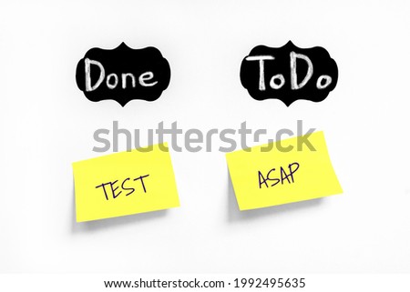 Yellow sticker with text Test and ASAP on white Whatman paper. Chalk text Done and ToDo on black labels. Concept testing, starting test. Handwriting text close up isolated, copy space. Royalty-Free Stock Photo #1992495635