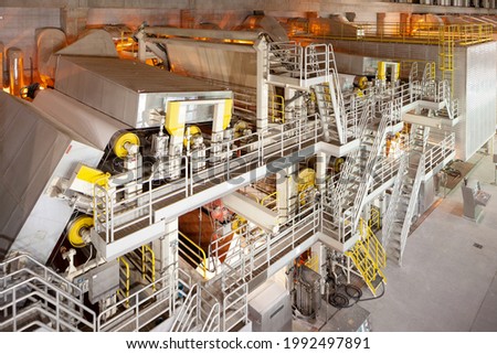 The machinery in a paper mill plant. Royalty-Free Stock Photo #1992497891