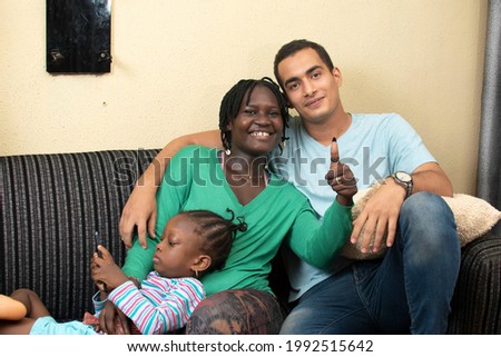 interracial couple having a family time.black woman gives a thumbs up