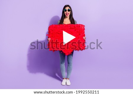 Full size photo of happy excited good mood positive girl hold huge paper play button isolated on purple color background