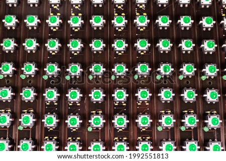 Close-up of a LED panel of green light indicators is in the production. The concept of industrial production of equipment for military and strategic purposes