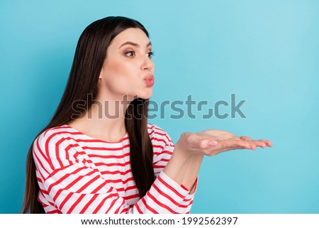 Profile photo of sweet brunette hairdo young lady blow kiss empty space wear red shirt isolated on blue color background