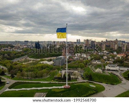 Flag of Ukraine on a high flagpole. Aerial drone view.