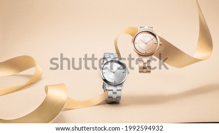 Luxury women watches floating on ribbom on seamless background concept Royalty-Free Stock Photo #1992594932