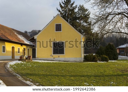 Yellow farmhouse in the evening winter light