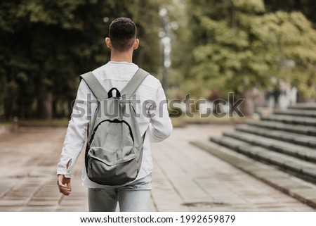 Young student going to university. Shot from behind. Royalty-Free Stock Photo #1992659879