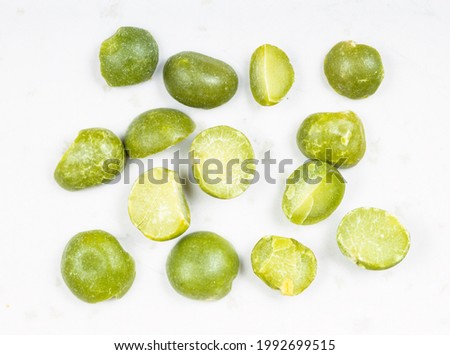 several raw dried green split peas close up on gray ceramic plate Royalty-Free Stock Photo #1992699515