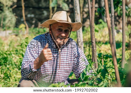 farmer in the garden with sign of success and approval