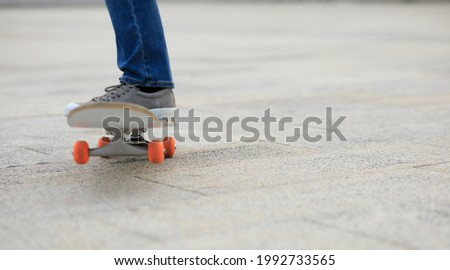 Blur Skateboarder legs skateboarding at outdoors