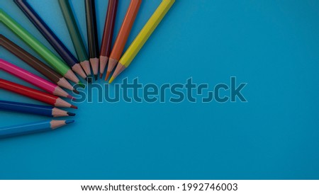 Colored pencils on a blue background. Great For Your Back To School. Art Supplies Related Projects.
