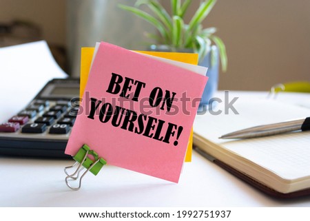 Text bet on yourself on the short note texture background