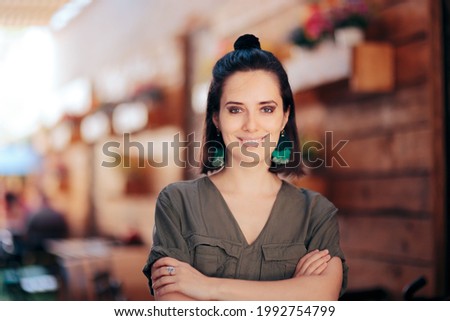 Cool Fashionable Woman with Hair Bun and Tassel Earrings. Trendy cool millennial girl wearing matching jewelry to her outfit
