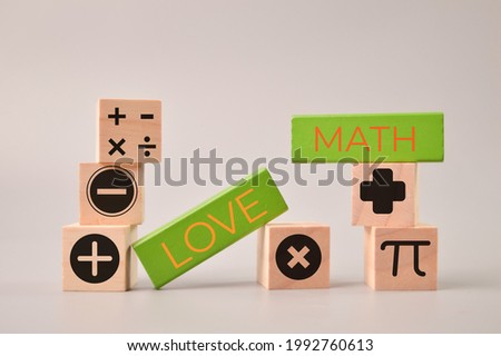 Wooden blocks with text LOVE MATH and math symbols