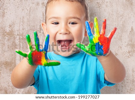 portrait of cute kid playing with paint