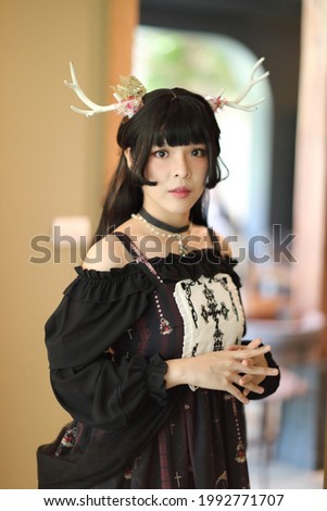 Portrait of asian girl in lolita fashion dress in vintage garden background